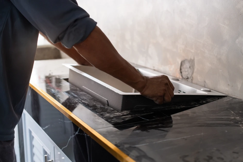 plumber installing kitchen sink